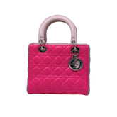 Fuchsia quilted handbag with pink handles, gray sides, and silver hardware rings