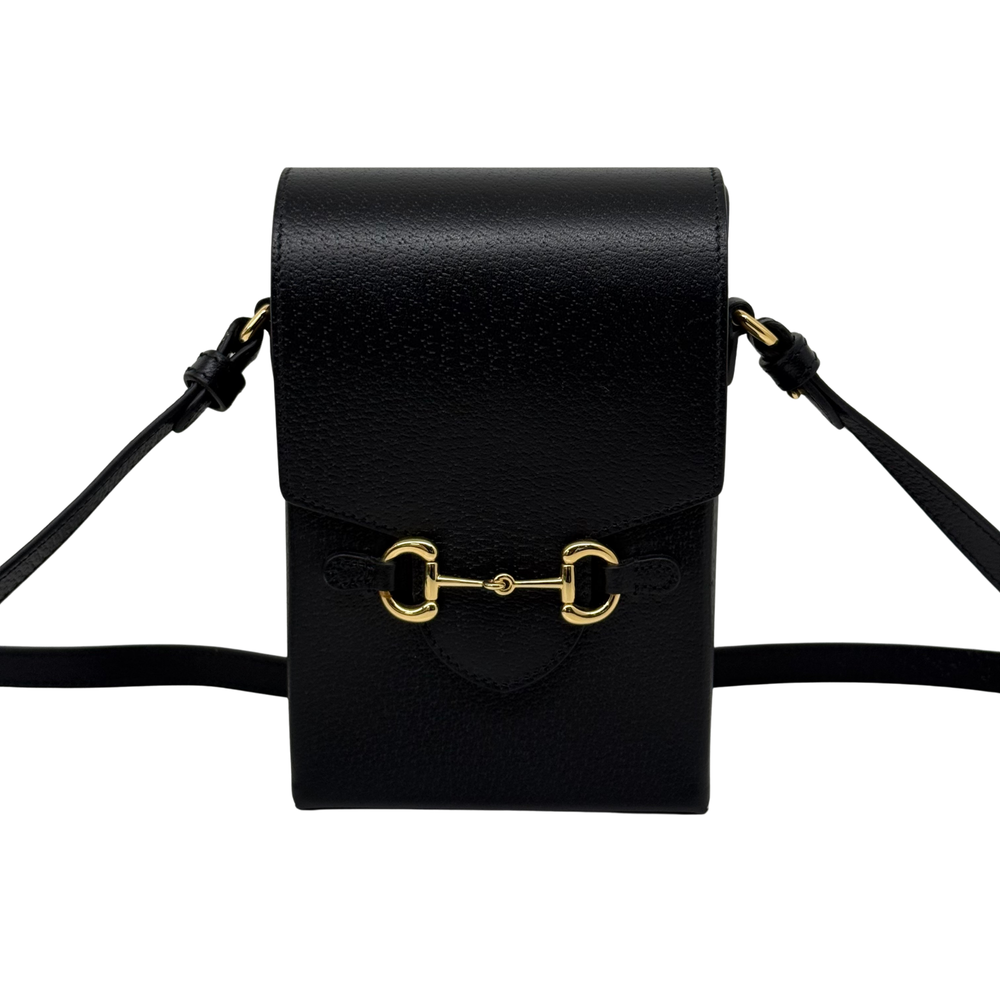 Black leather crossbody bag front flap and shoulder strap
