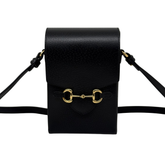 Black leather crossbody bag front flap and shoulder strap