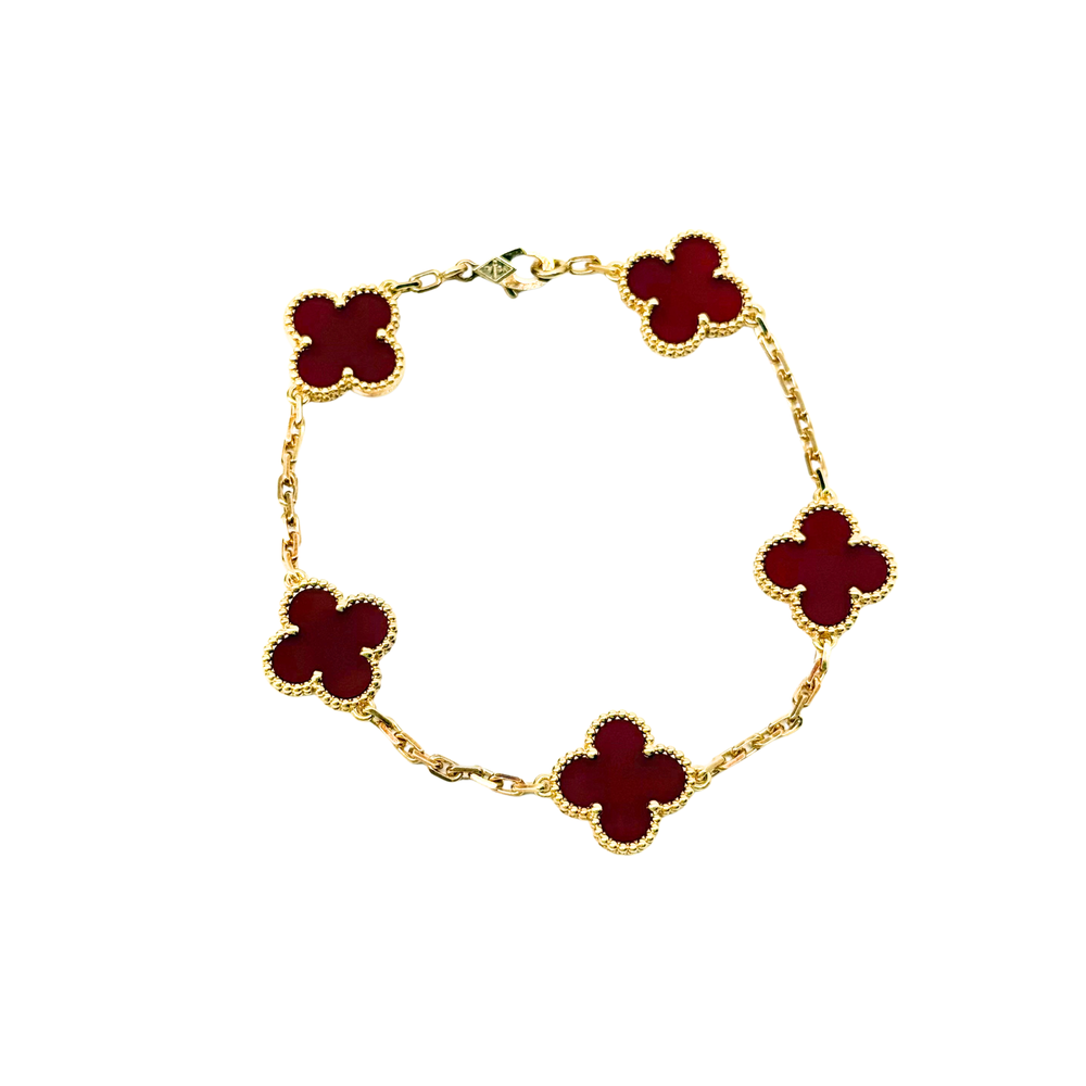 Gold bracelet with five red quatrefoil charms, round chain links
