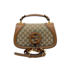 Gucci small handbag with GG canvas front, brown leather handle, and detachable strap