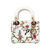 Pre-owned mini handbag with white leather floral print, single top handle, gold hardware