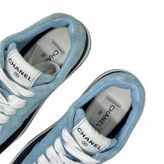 Blue suede sneaker interior with CHANEL logo on tongue and white laces