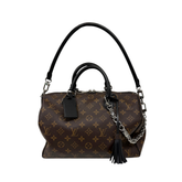 Pre-owned Louis Vuitton monogram handbag with chain strap, black tassel, leather handles