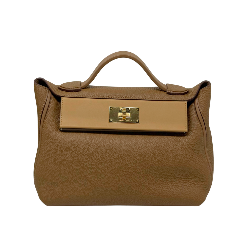 Taupe leather handbag with top handle and rectangular gold front clasp