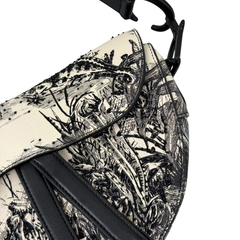Black-and-white calfskin saddle bag with palm toile print flap and black strap hardware