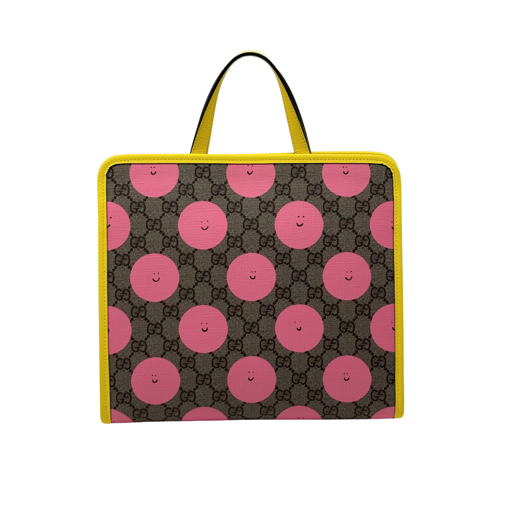 Gucci GG Supreme backpack front view with pink smiley circle print and yellow trim handles
