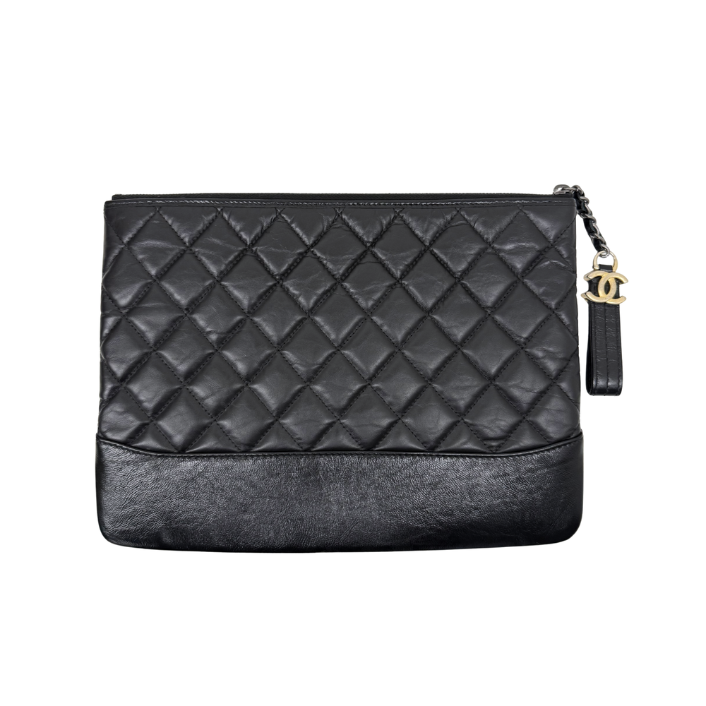 Black quilted leather clutch bag back view with zip top and chain strap with CC charm.
