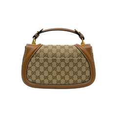 Monogram canvas mini shoulder bag with tan leather handles and contrast trim