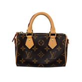 Monogram handbag with short handles and zip top, side view