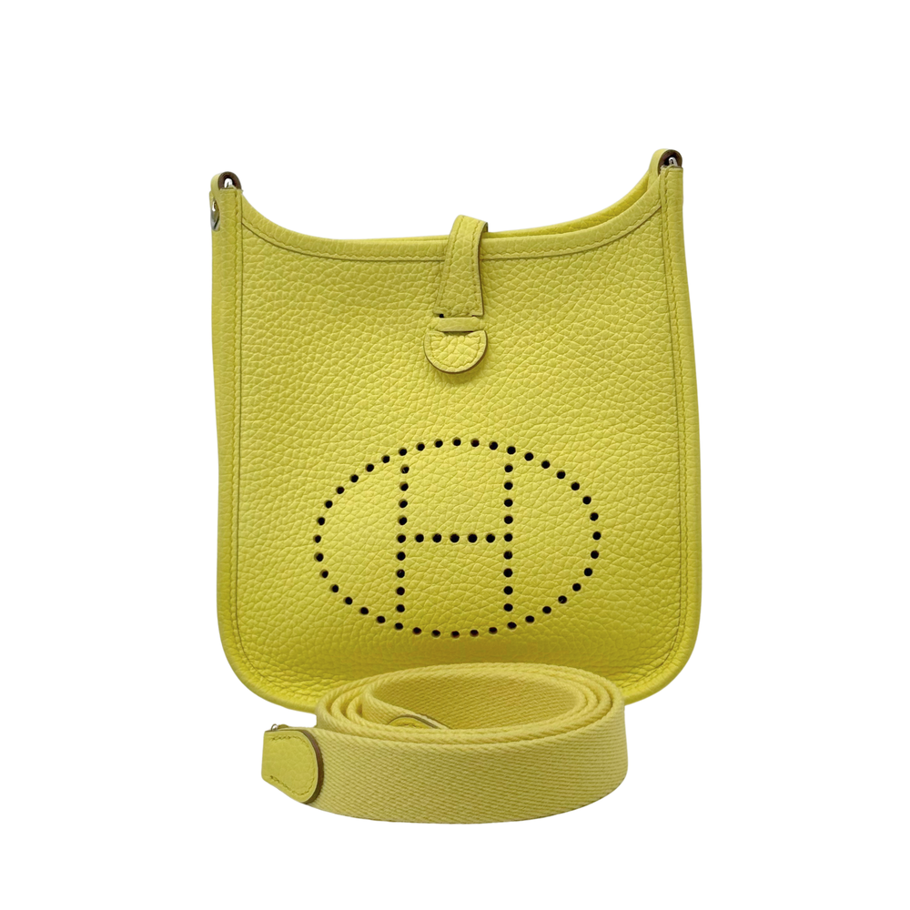 Yellow Clemence crossbody bag with perforated emblem front and adjustable strap