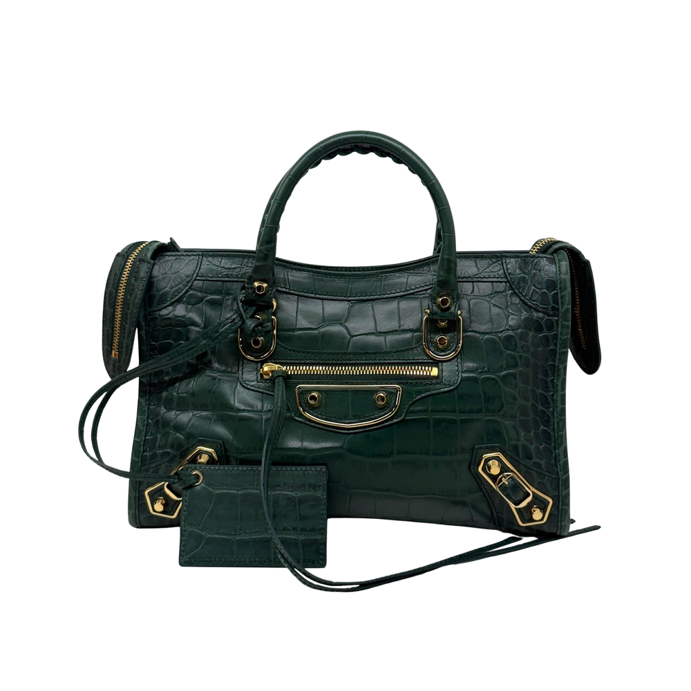 Dark green embossed small tote bag with top handles, crossbody strap, and zip pockets