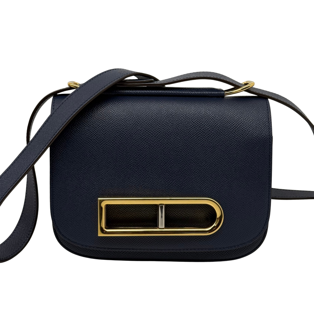 Navy leather crossbody satchel with gold clasp, curved flap and shoulder strap