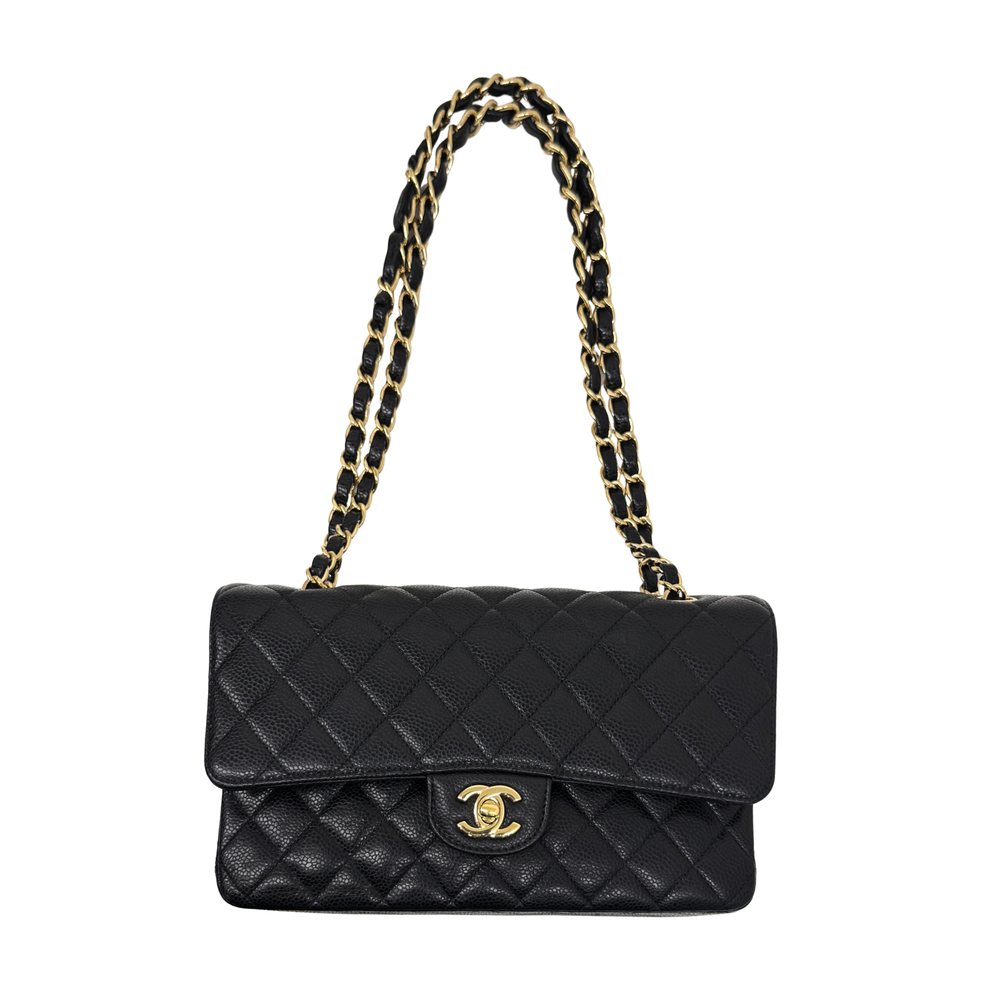 Black caviar double-flap shoulder bag on chain strap with gold CC clasp and quilted body.