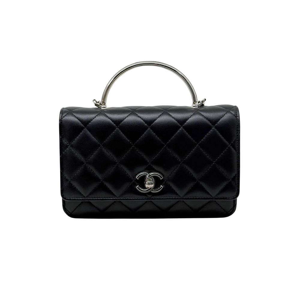 Black quilted leather flap crossbody bag with silver logo clasp and top handle