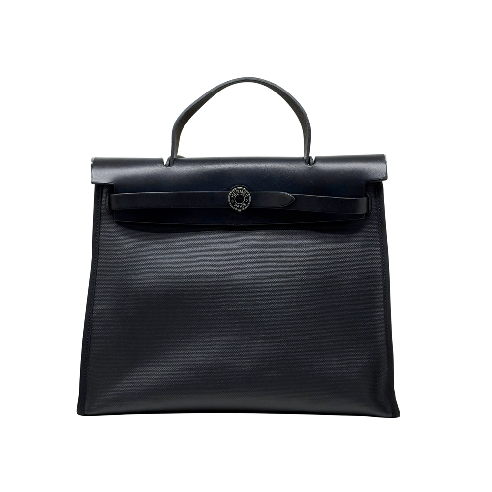 Black leather Hermes tote bag with top handle and front flap clasp