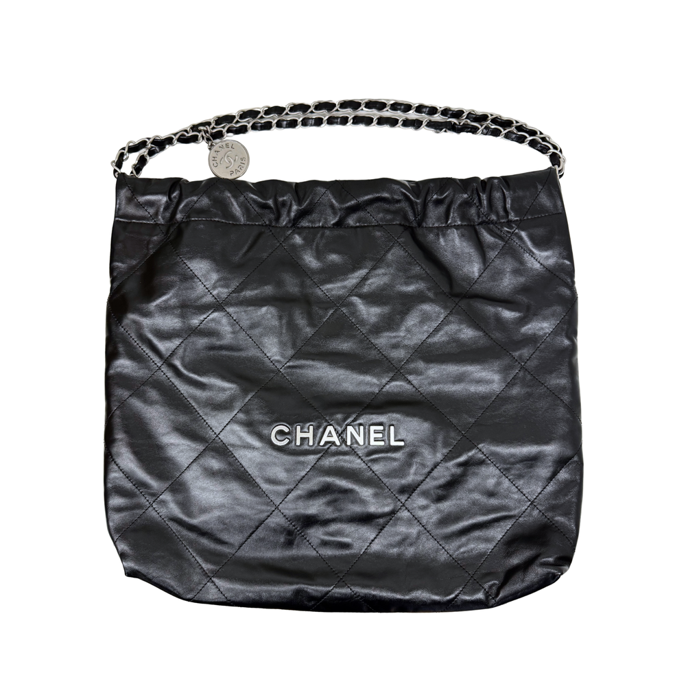 Black quilted hobo bag with chain top handle and CHANEL logo center