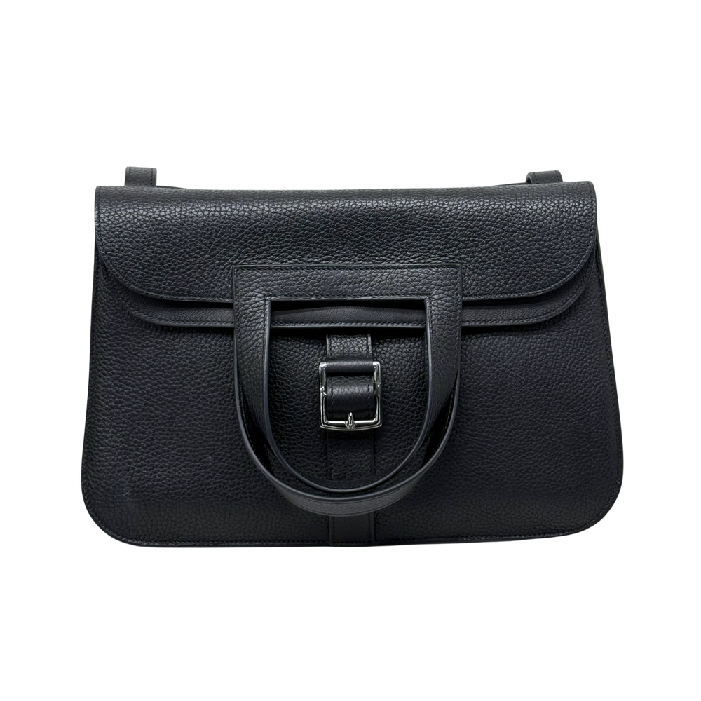 Black leather tote bag with structured flap and front buckle detail