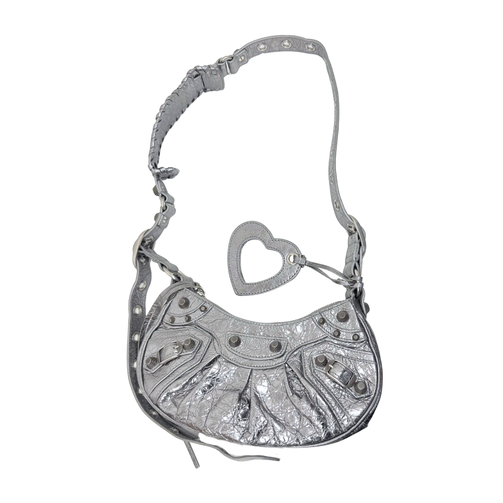 Balenciaga Le Cagole XS shoulder bag crossbody with heart charm and shoulder strap.
