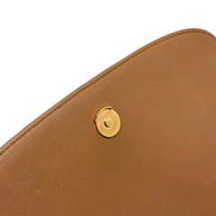 Tan leather bag panel with gold-tone snap button detail