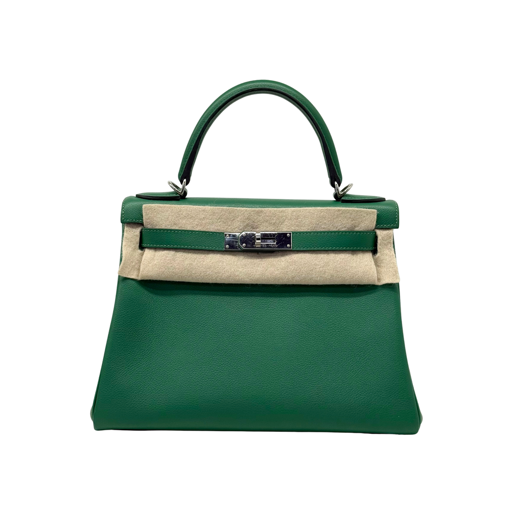 Green leather Kelly bag with top handle and front bar clasp over felt panel.