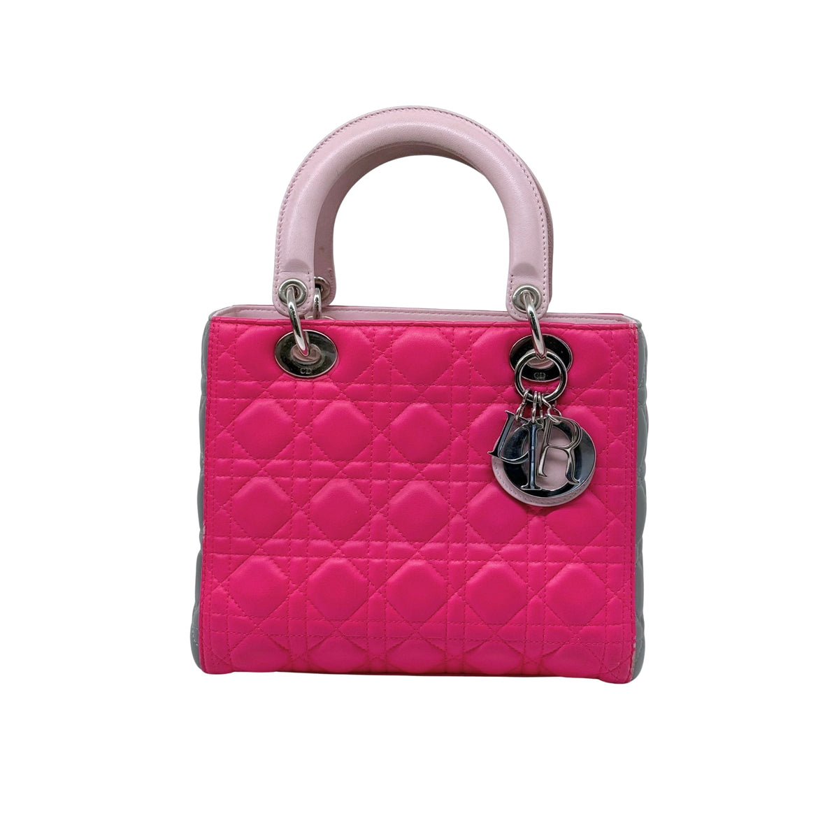 Fuchsia quilted handbag with pink handles, gray sides, and silver hardware rings