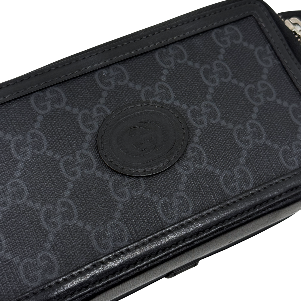 Small crossbody bag detail, dark GG monogram canvas with round logo patch