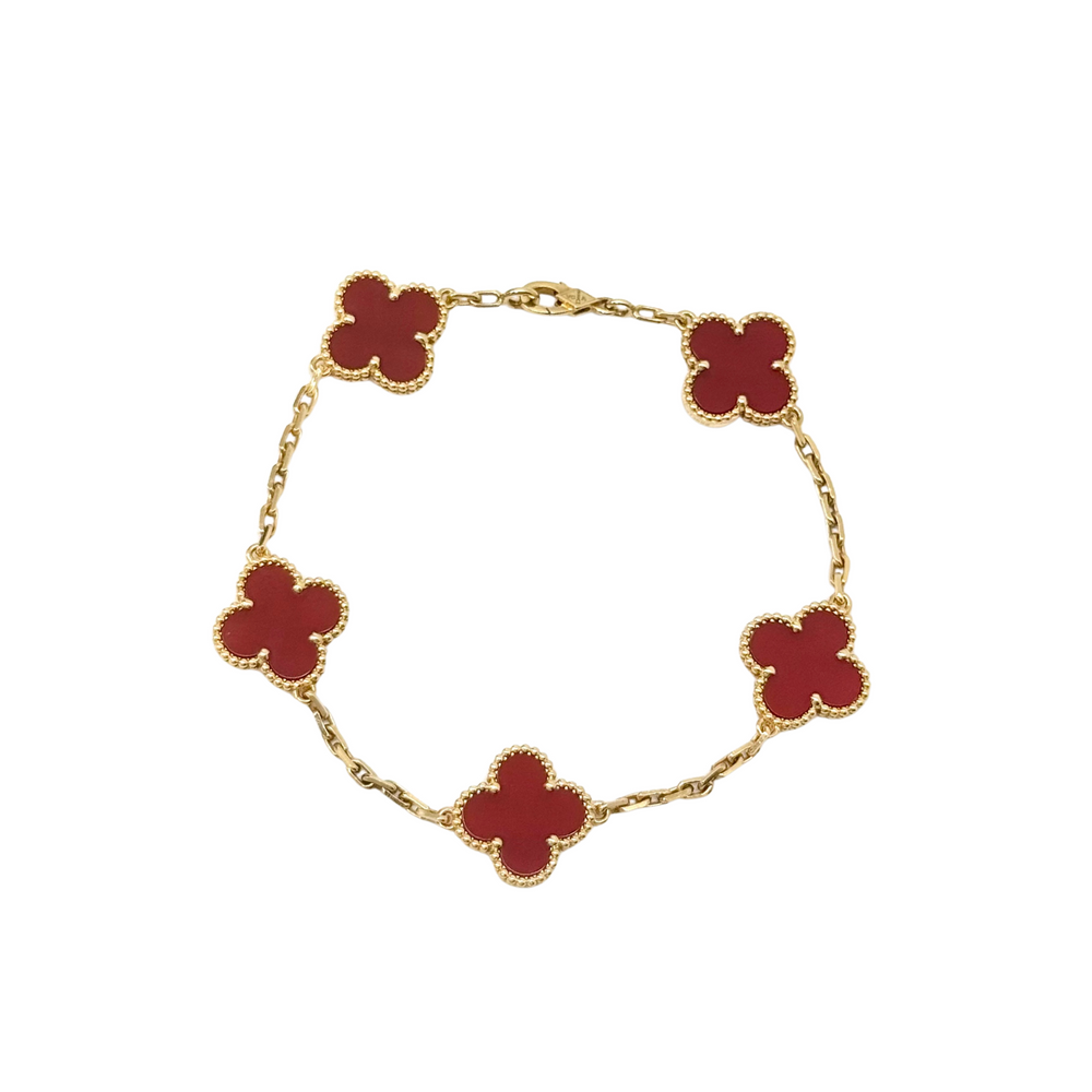 Goldtone bracelet with five red clover motifs on linked chain, full view