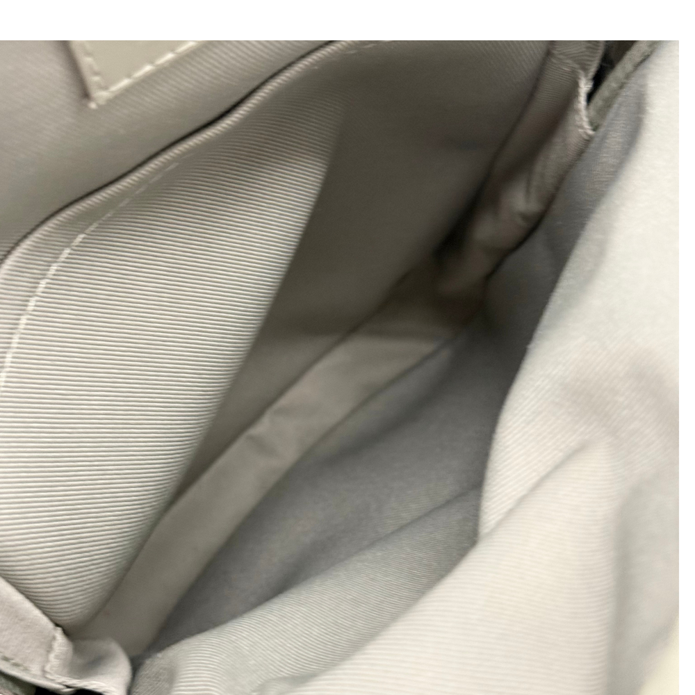 Pre-owned crossbody bag lining with stitched panel and structured interior pocket