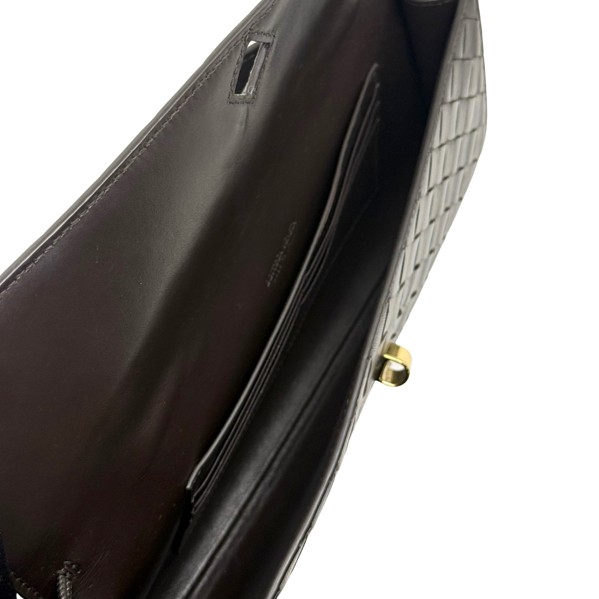 Black woven leather flap bag interior with gold snap hardware