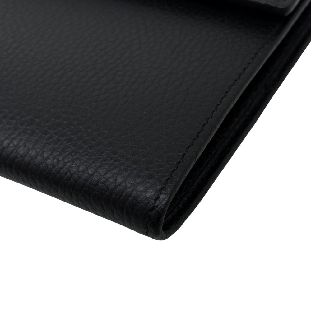 Black leather wallet front panel with corner seam and textured finish