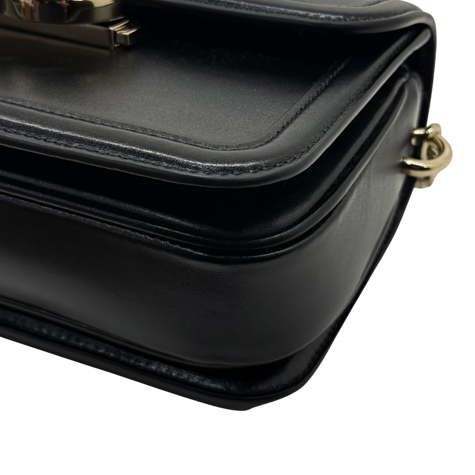 Black leather flap with curved stitching detail