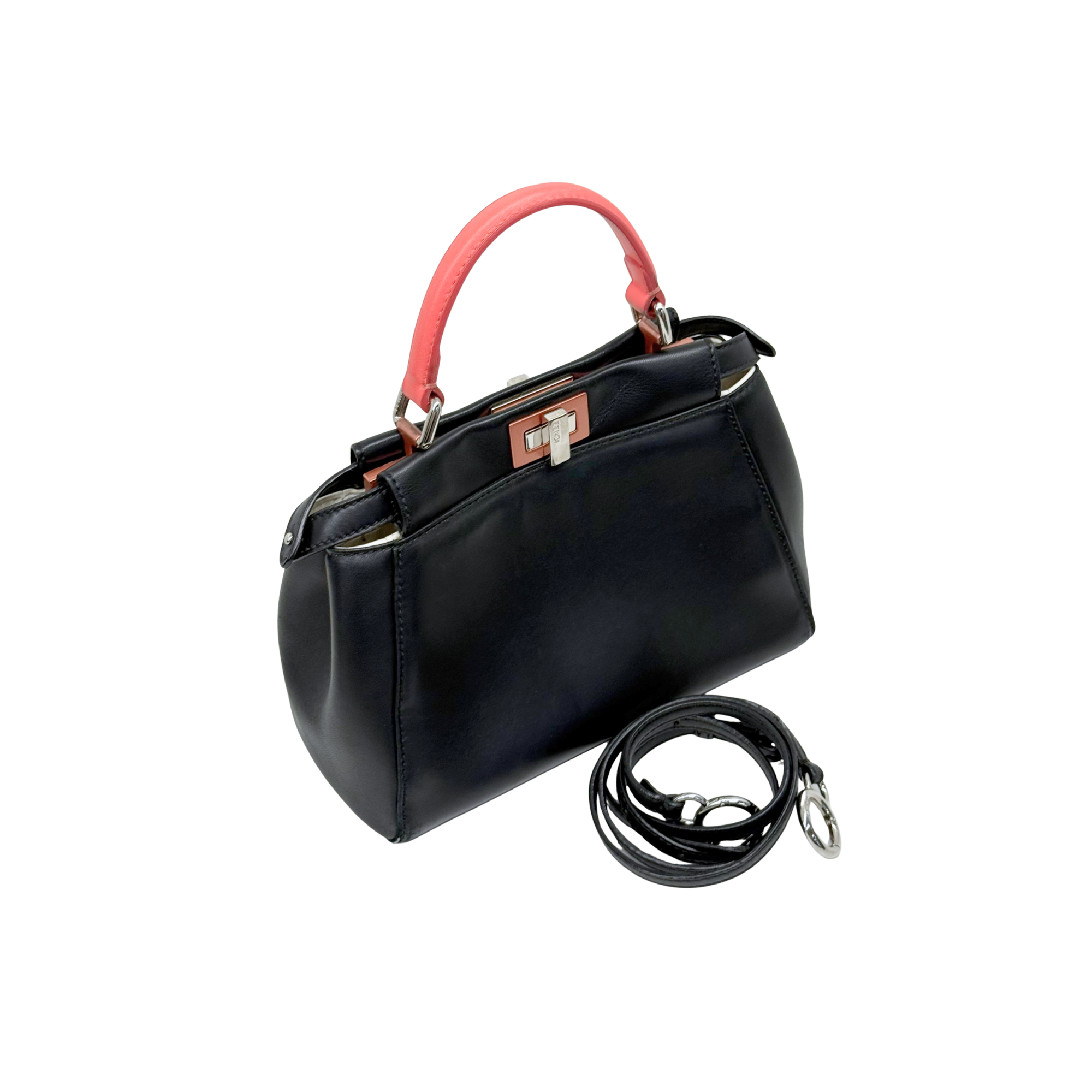 Black handbag with red handle and black adjustable shoulder strap