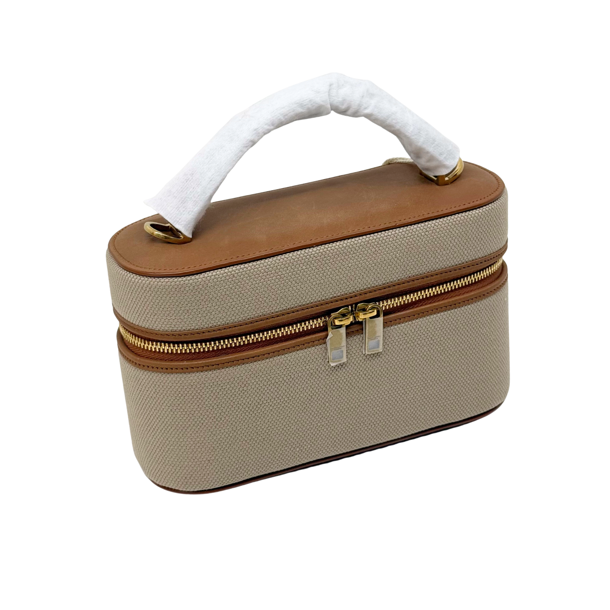 Beige top-handle vanity bag with brown leather trim and centered gold zipper