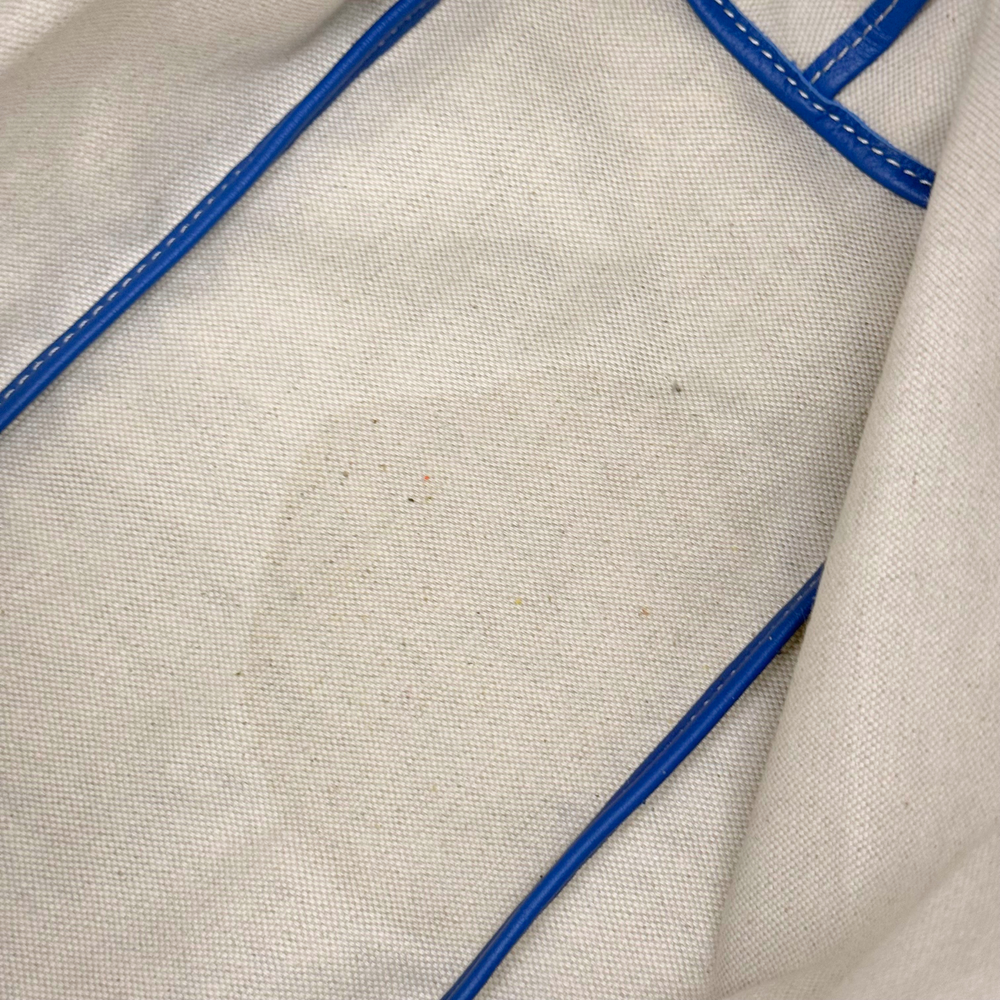 Handbag lining panel with blue piping and subtle textured fabric