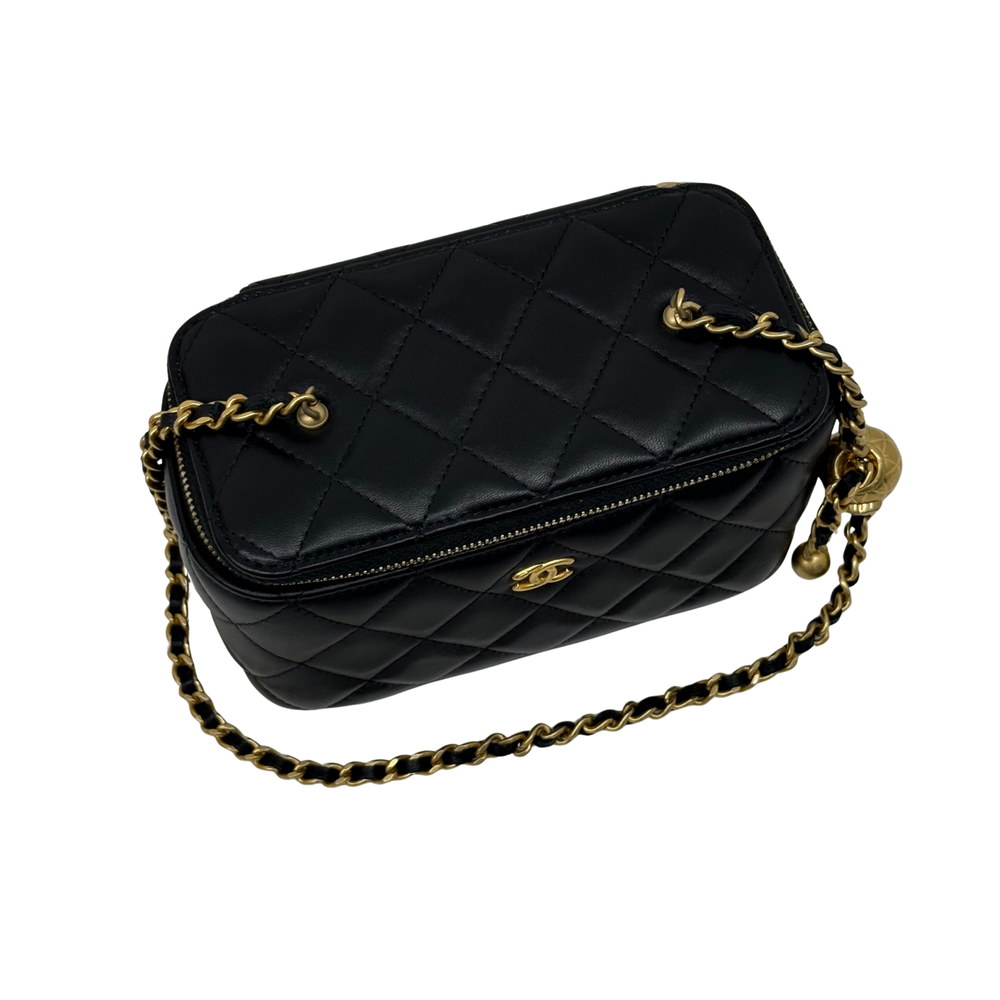 Black quilted leather crossbody bag with CC emblem, gold chain, and zip top