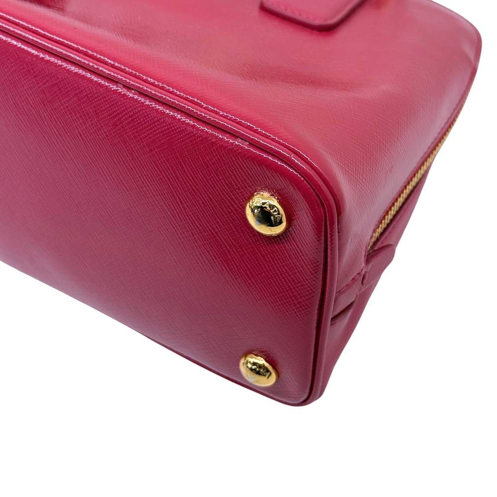 Prada pink handbag corner with gold stud feet and textured leather look