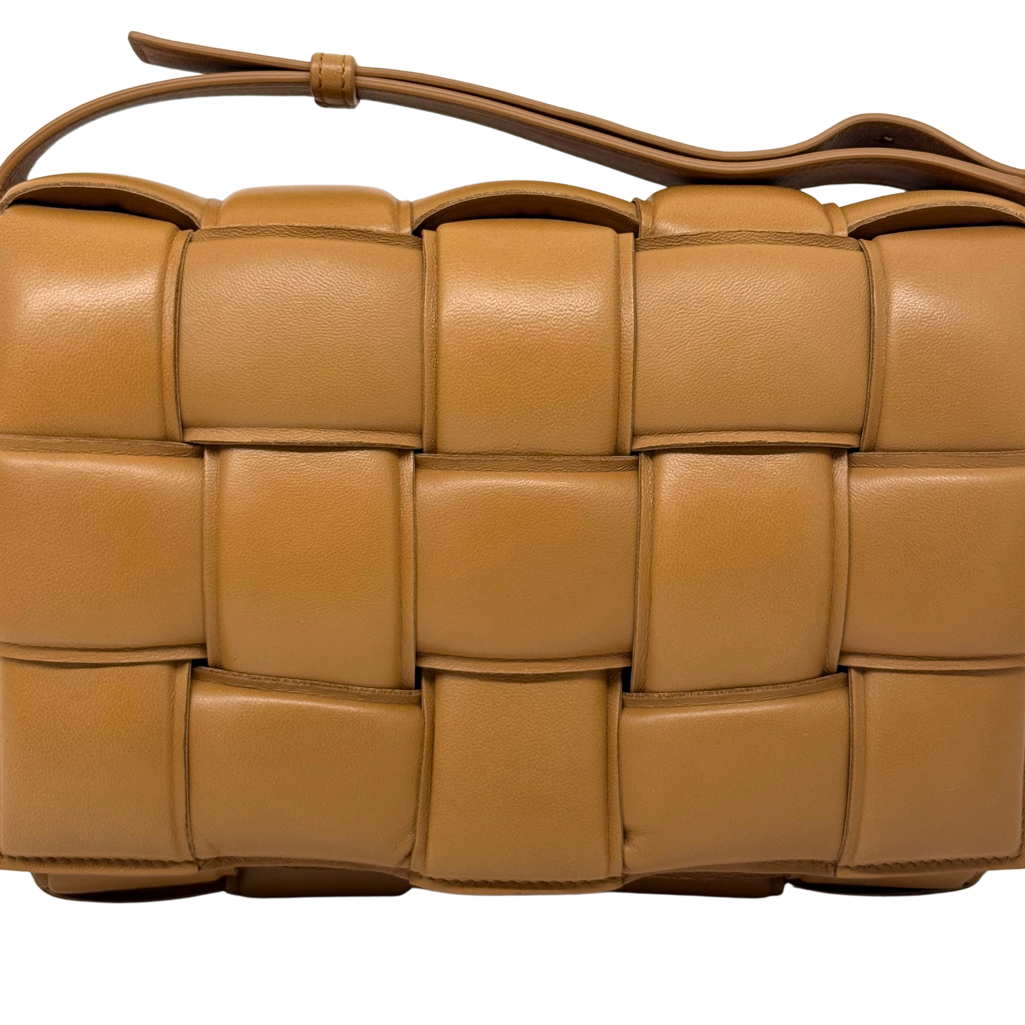 Tan quilted leather bag front detail with interlocking padded squares