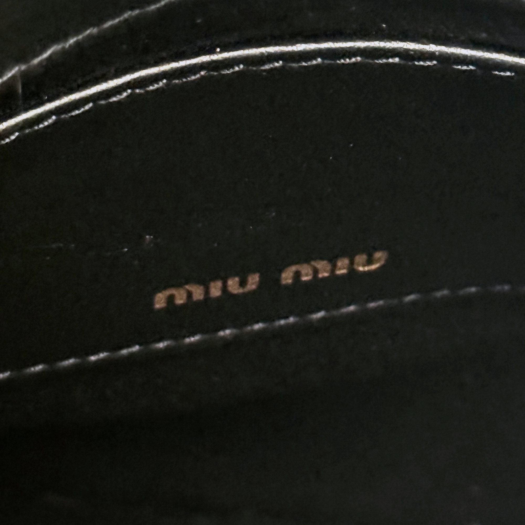Miu Miu black leather interior label with small embossed logo