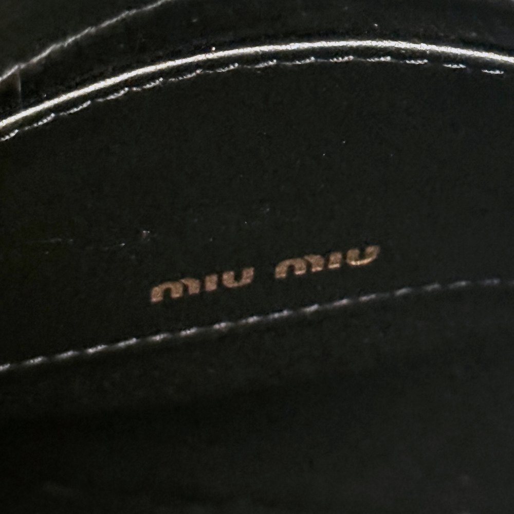 Miu Miu black leather interior label with small embossed logo