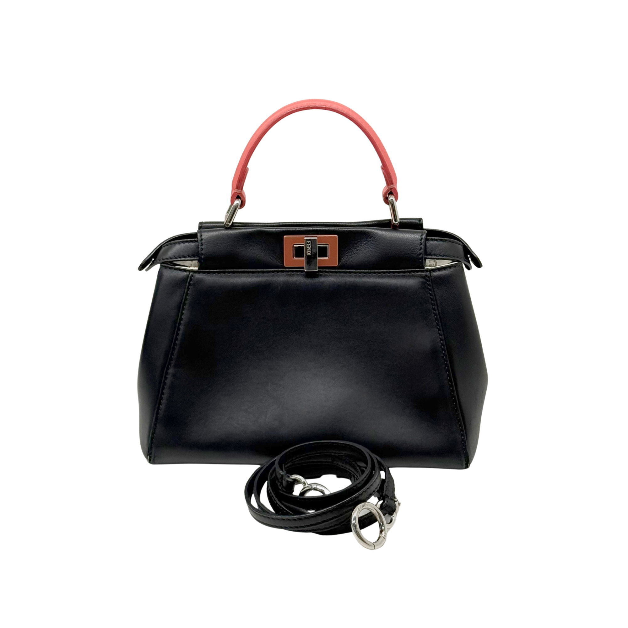 Black handbag with red top handle and attached black crossbody strap