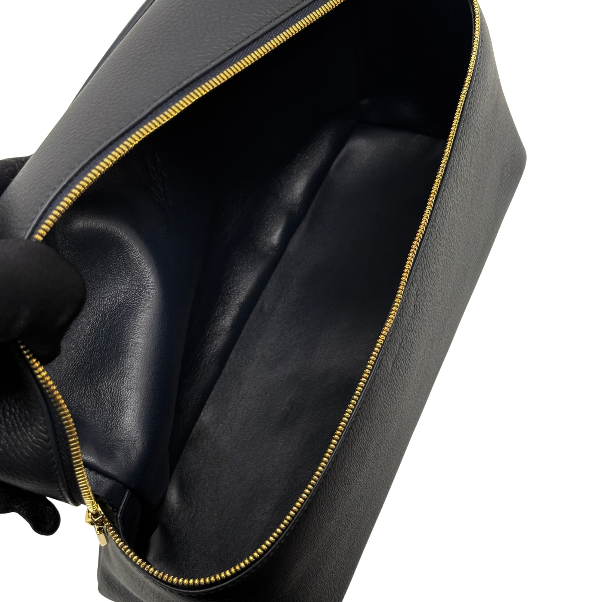 Black leather zip opening with gold-trim zipper edge