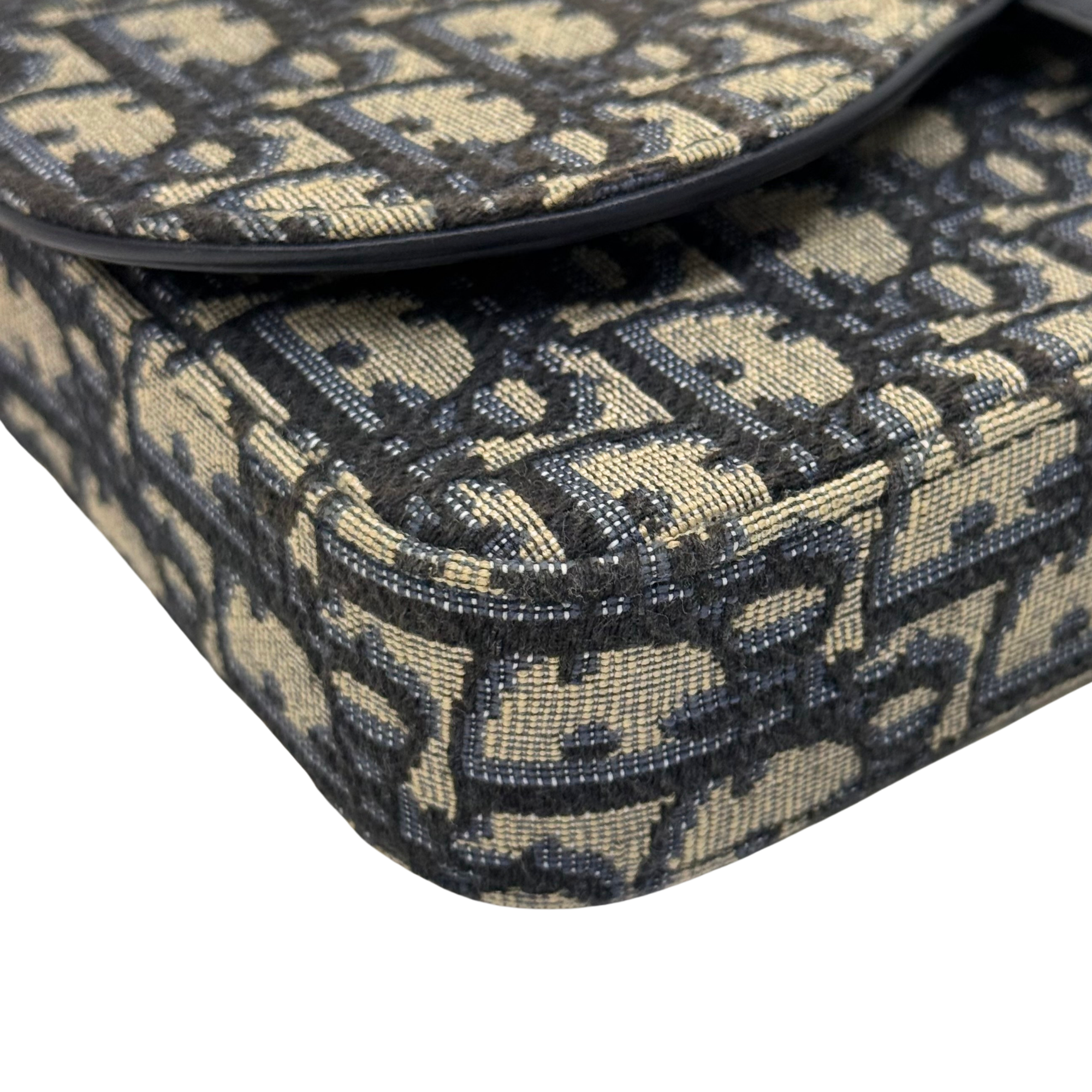 Dior monogram bag edge with stitched canvas trim and curved black leather piping