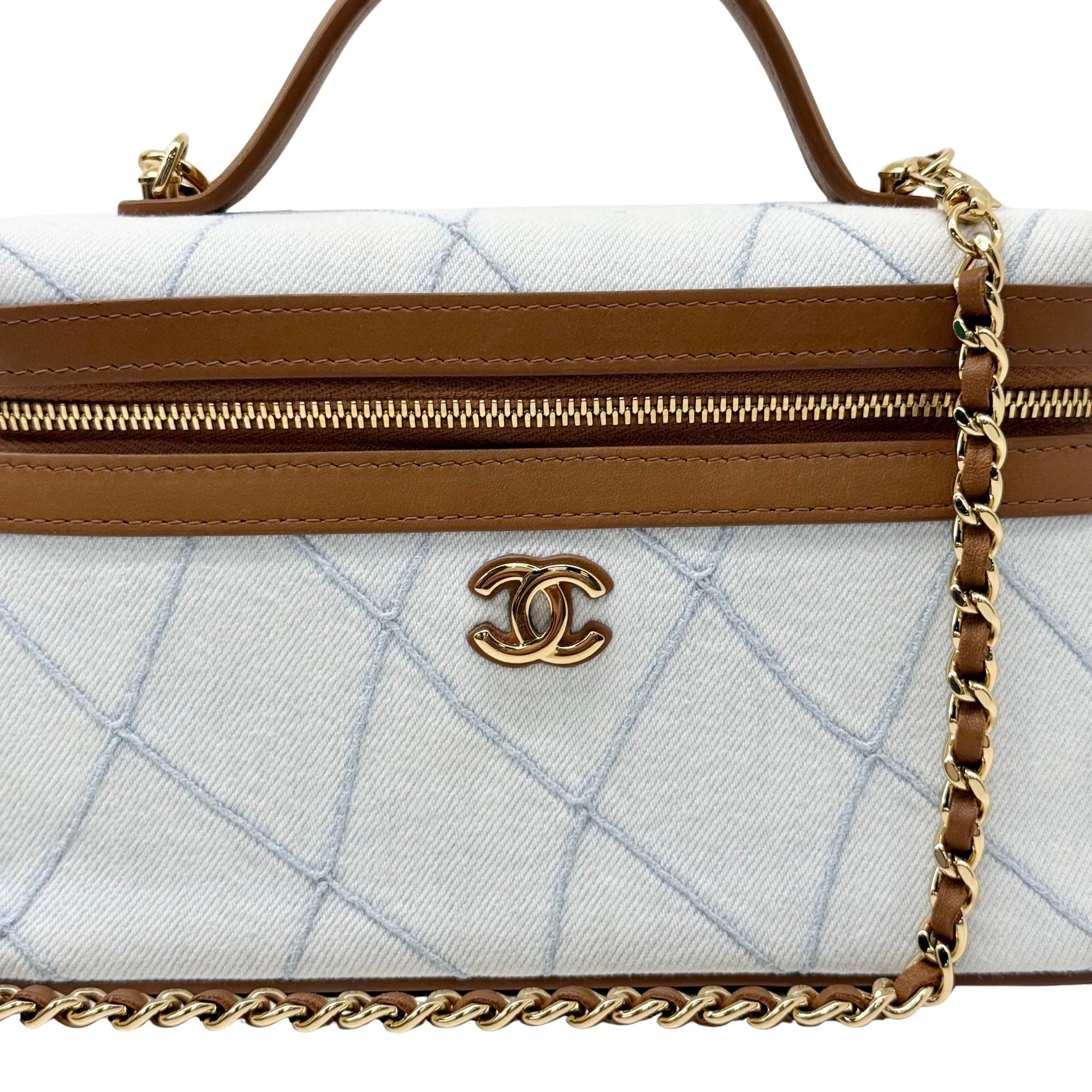 Chanel quilted light blue handbag front with gold zipper, logo, and chain strap