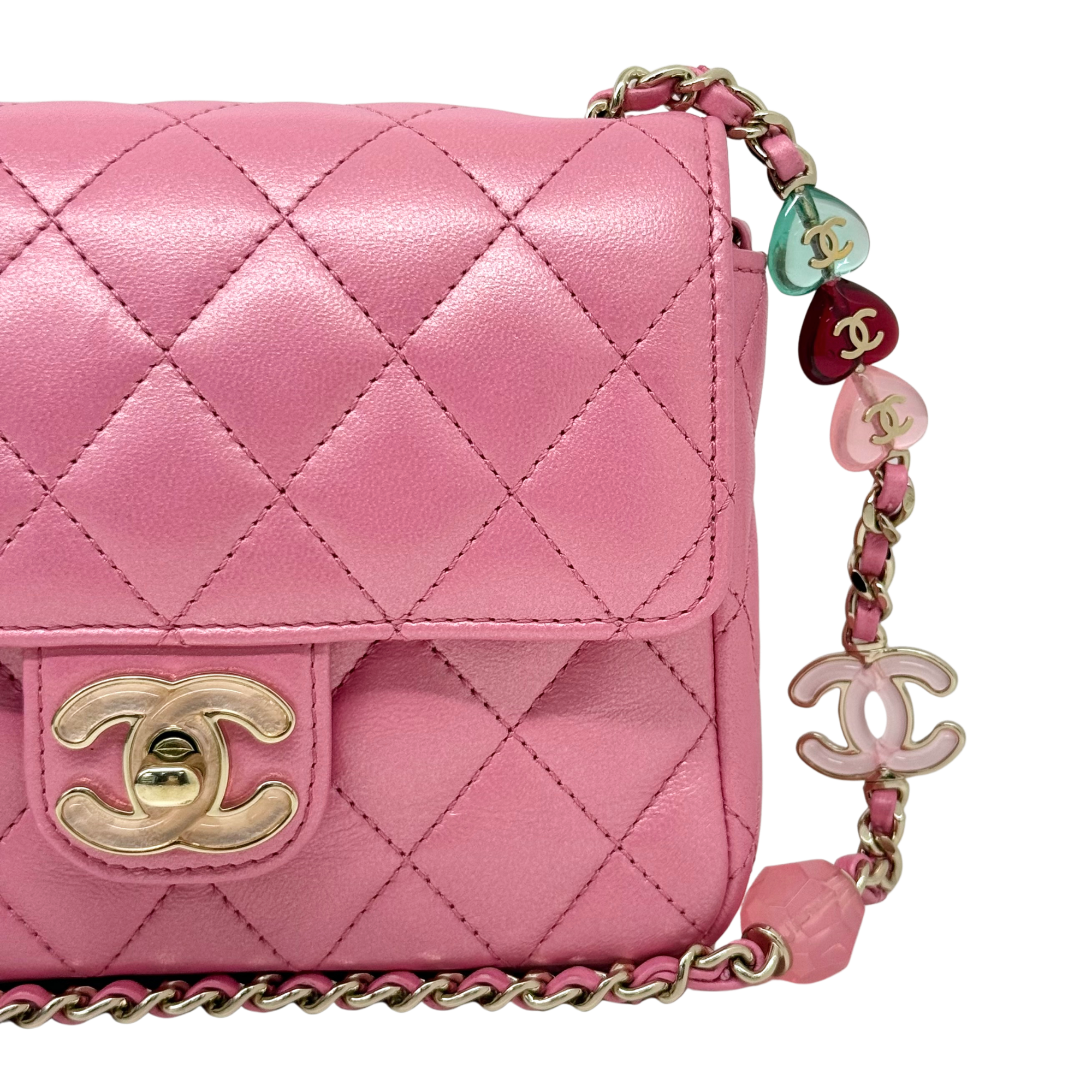 Chanel quilted pink flap bag with gold CC turn-lock and multicolor charm chain