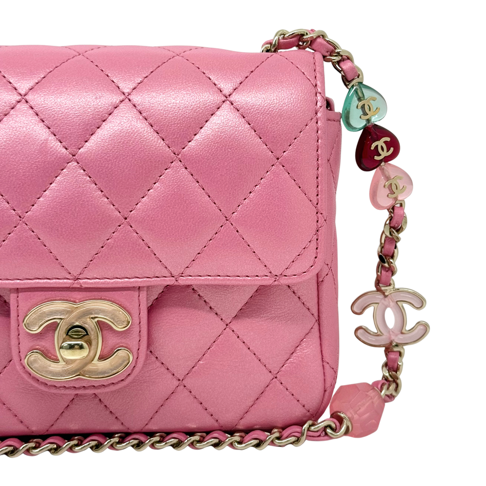 Chanel quilted pink flap bag with gold CC turn-lock and multicolor charm chain
