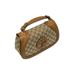 Monogram canvas shoulder bag with tan leather trim and gold logo emblem