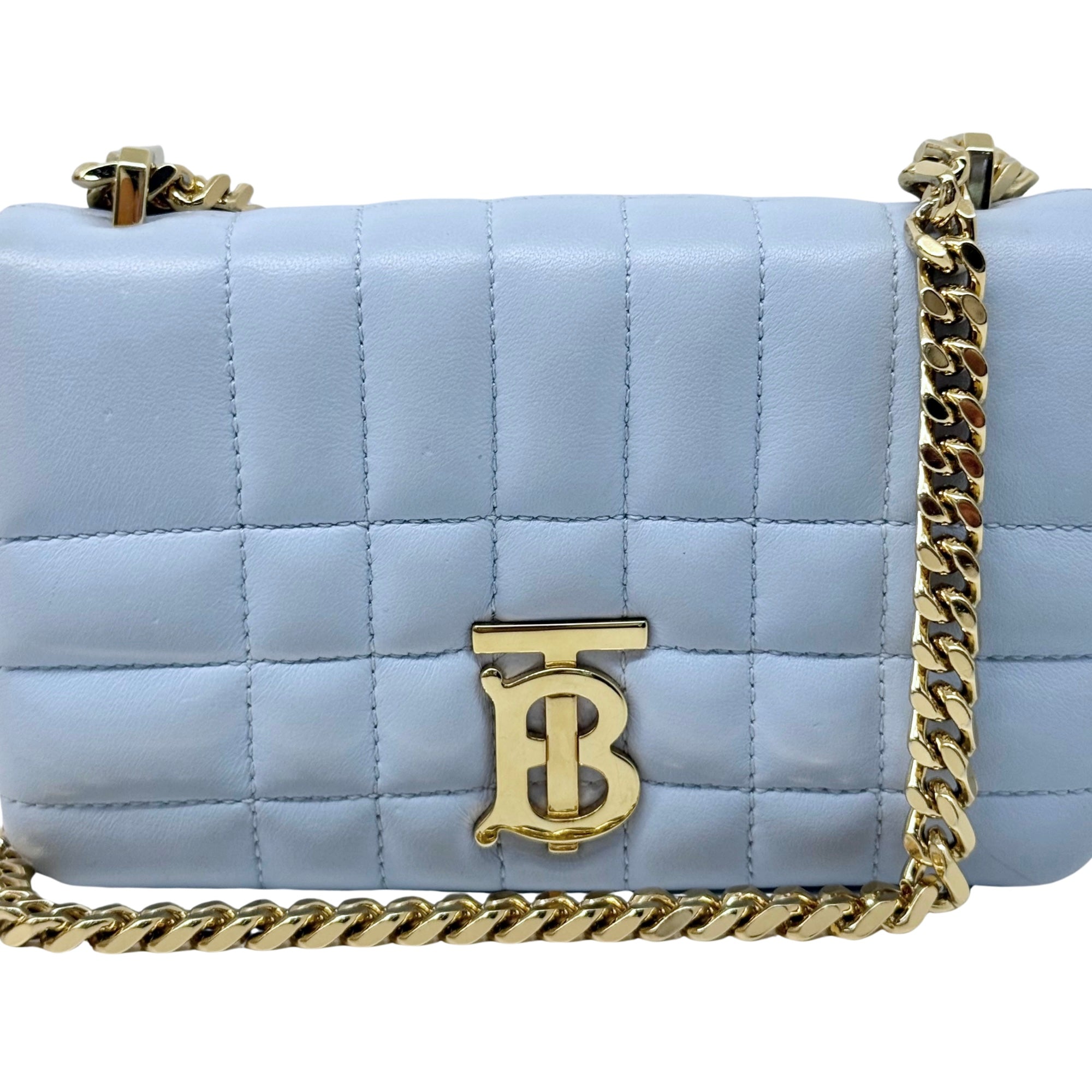 Light blue quilted leather shoulder bag with gold B emblem and gold chain strap.