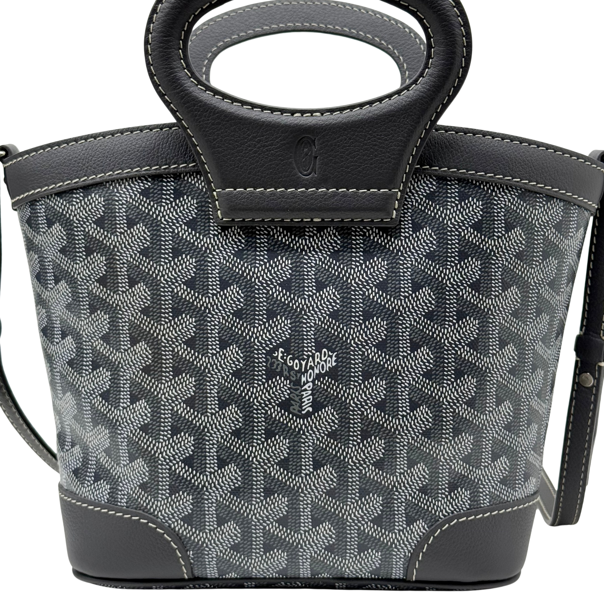 Pre-owned Goyard bag front with patterned canvas, leather base, and top handle emblem