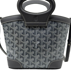 Pre-owned Goyard bag front with patterned canvas, leather base, and top handle emblem